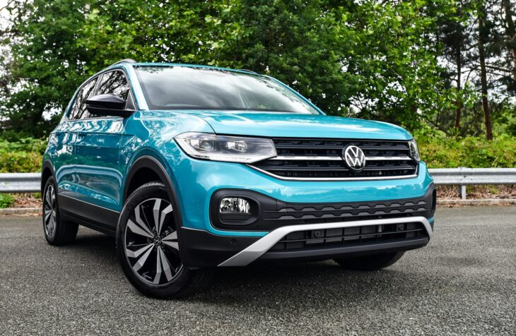 a blue volkswagen suv parked in a parking lot